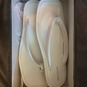 Pretty Little Thing white leather flip flops (size 9)